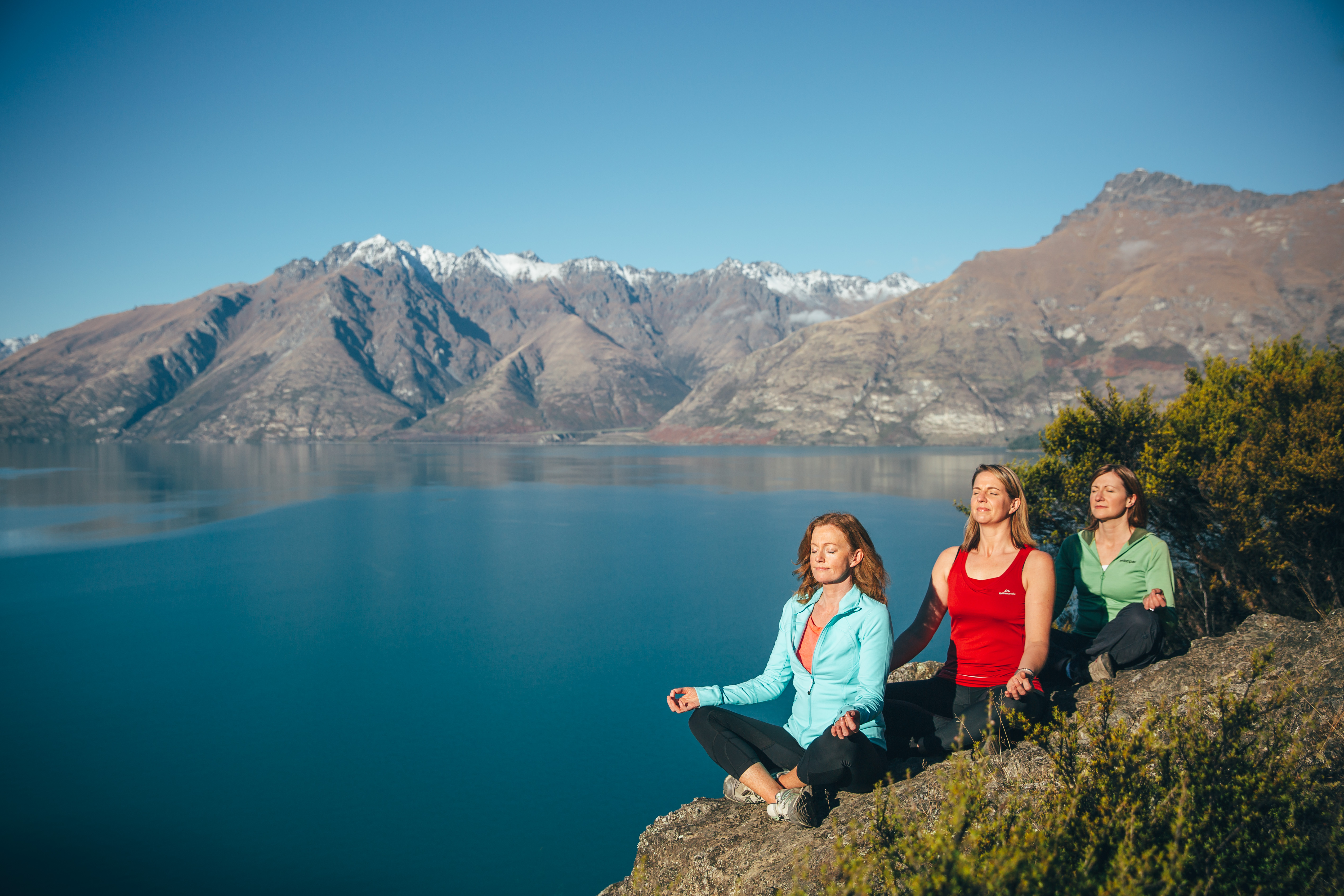 Soul Journeys participants meditate on a hill overlooking Lake Wakatipu PHOTO supplied